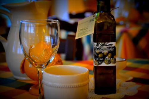 a bottle of wine and a glass on a table at Agriturismo Salinola in Ostuni