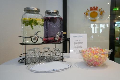 a table with jars and a bowl of candy at Hotel Sophienhof in Königs Wusterhausen