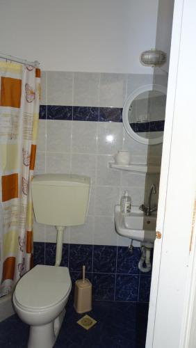 a bathroom with a toilet and a sink at Hermes-Ios Rooms To Let in Ios Chora