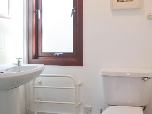 a bathroom with a sink and a toilet and a window at Chalet 3 - Uk30304 in Tore