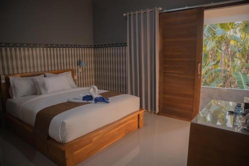 Кровать или кровати в номере Prasi Sunrise Homestay