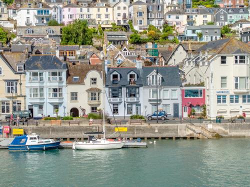 a group of boats docked in a harbor with buildings at Waterfront House in Dartmouth