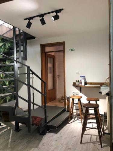 a room with two stools and a staircase in a house at MyHome2 in Subotica