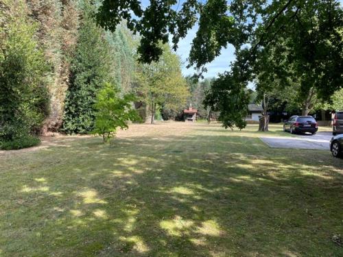 a large grass field with a car parked in it at Panoramic Bungalow Sint Gillis-Waas in Sint-Gillis-Waas