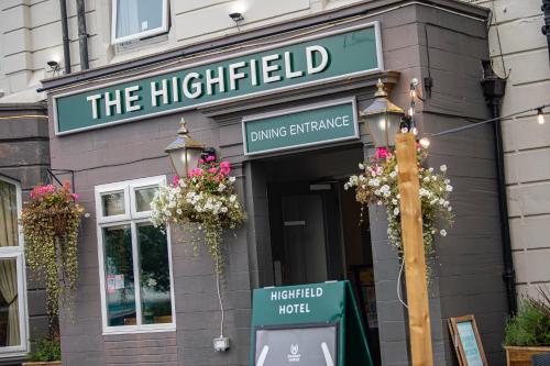 a building with a street light in front of it at Highfield Hotel By Greene King Inn in Middlesbrough