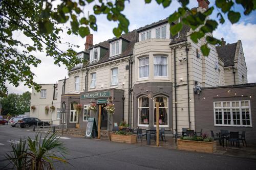 a building on the corner of a street at Highfield Hotel By Greene King Inn in Middlesbrough