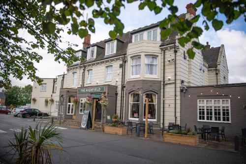 a building on the corner of a street at Highfield Hotel By Greene King Inn in Middlesbrough