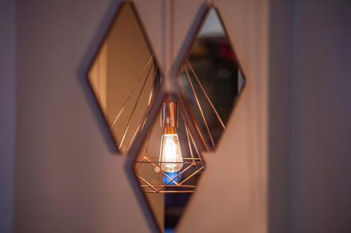 a light fixture hanging from a wall at Highfield Hotel By Greene King Inn in Middlesbrough