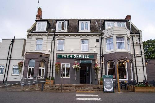 a building on the corner of a street at Highfield Hotel By Greene King Inn in Middlesbrough