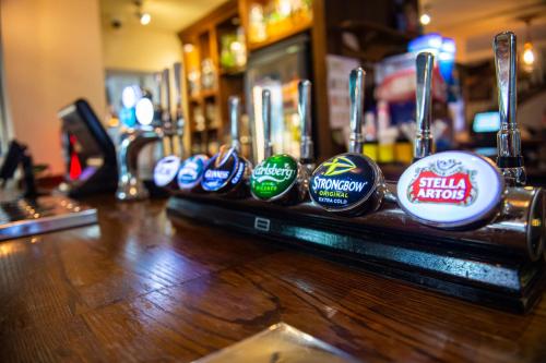 a bar with a row of balls on a counter at Highfield Hotel By Greene King Inn in Middlesbrough