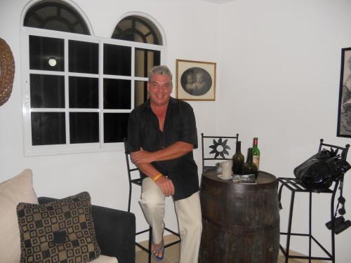 a man standing in a living room next to a barrel at Guesthouse Villa La Isla in La Romana