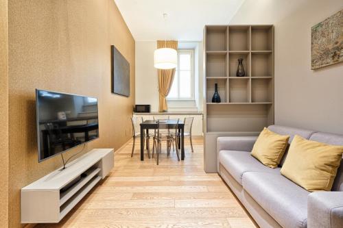 a living room with a couch and a tv at Palazzo Del Carretto-Art Apartments and Guesthouse in Turin