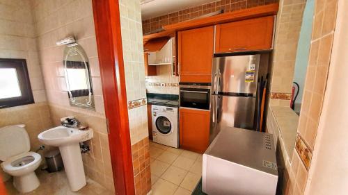 a small kitchen with a sink and a refrigerator at Prime Home The View Hurghada in Hurghada