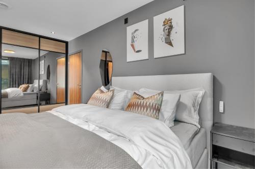 a bedroom with a large white bed with pillows at Penthouse in Downtown Tromsø NEW in Tromsø