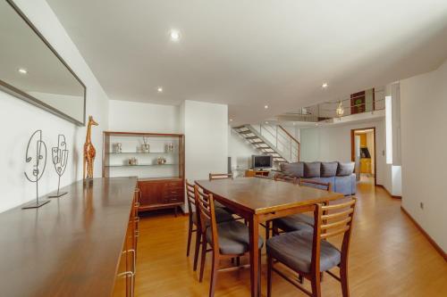 a dining room and living room with a table and chairs at OPORTO GUEST Oliveira House in Porto