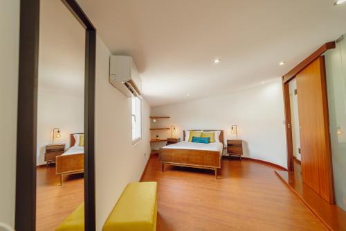 a hotel room with a bed and a mirror at OPORTO GUEST Oliveira House in Porto