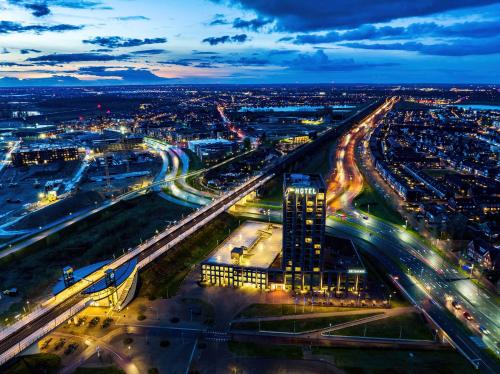 an aerial view of a city at night at Van der Valk Hotel Nijmegen-Lent in Nijmegen
