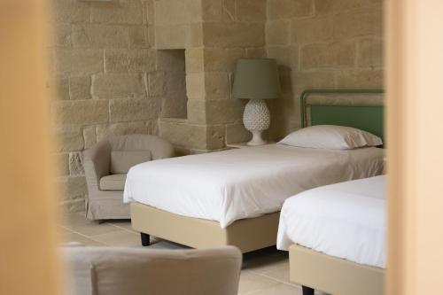 Ένα ή περισσότερα κρεβάτια σε δωμάτιο στο MASSERIA LILEI