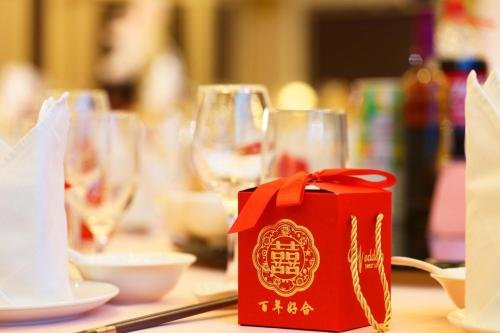 a table with wine glasses and a red box on it at Holiday Inn Foshan Nanhai Central by IHG in Foshan