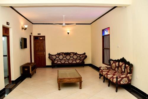 a living room with two couches and a coffee table at Minara Miwili - Forodhani Park in Zanzibar City