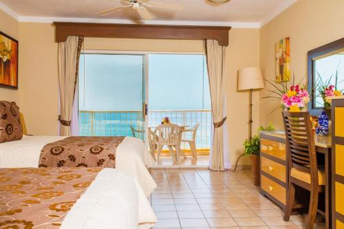 a bedroom with a bed and a view of the ocean at Suites at Villa Del Palmar Cabo San Lucas Beach Resort and Spa in Cabo San Lucas