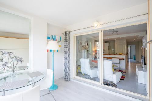 a living room with a glass table and white chairs at Apartment Zeus in Calpe