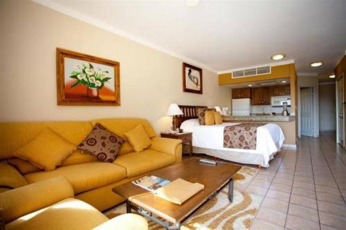 a living room with a couch and a bedroom at Suites at Villa Del Palmar Cabo San Lucas Beach Resort and Spa in Cabo San Lucas