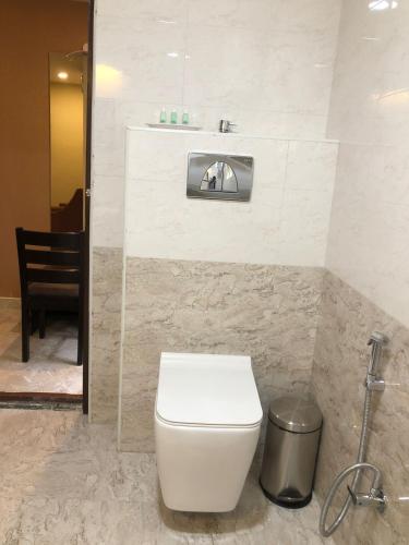 a bathroom with a toilet and a sink at Eshanya Comforts in Attibele