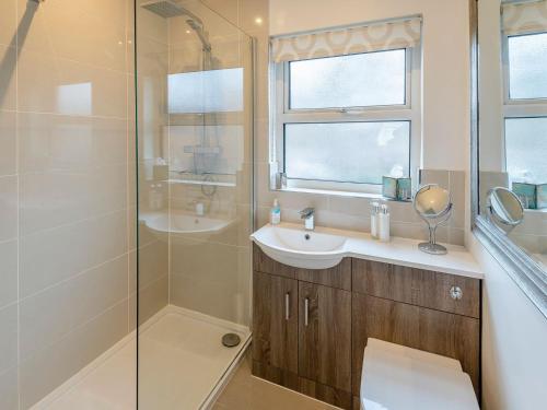a bathroom with a shower and a sink and a mirror at Strugglers Retreat - Uk32878 in Lincoln