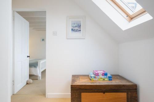 a room with a wooden table and a skylight at Seaside cottage on Moray coast in Portknockie