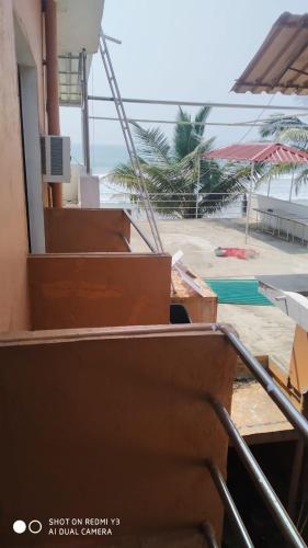 a view of the beach from the stairs of a building at Saritas Guest House - Bogmalo Beach in Bogmolo