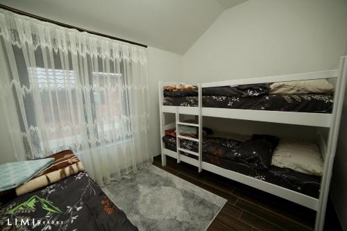 a bedroom with two bunk beds and a window at Limi-Resort in Peje