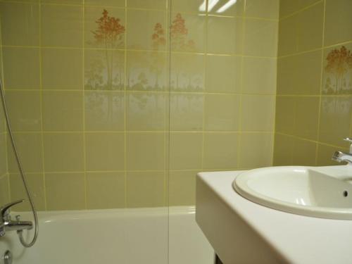 a bathroom with a shower and a sink and a tub at Studio Les Menuires, 1 pièce, 3 personnes - FR-1-452-3 in Les Menuires