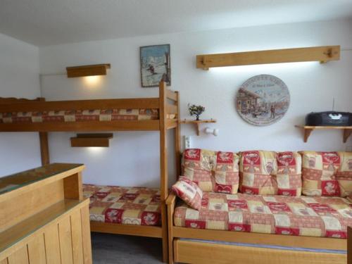 sypialnia z łóżkiem piętrowym, łóżkiem i kanapą w obiekcie Studio Les Menuires, 1 pièce, 3 personnes - FR-1-452-103 w Les Menuires