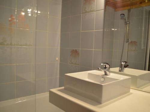 a bathroom with a sink and a mirror at Studio Les Menuires, 1 pièce, 3 personnes - FR-1-452-103 in Les Menuires