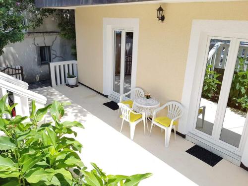 a patio with a table and chairs on a house at Montenegro Apartmant's in Kotor