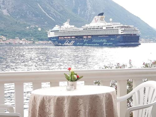 a cruise ship on the water with a table with a tablestration at Montenegro Apartmant's in Kotor