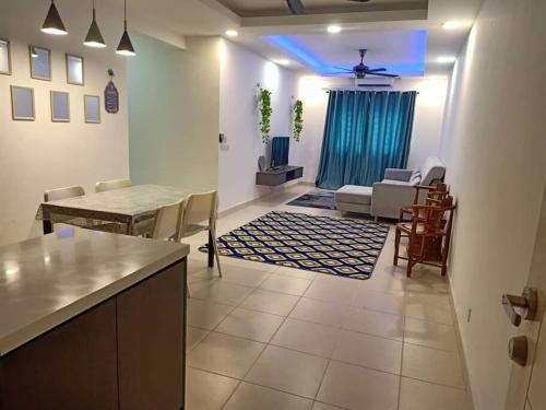 a kitchen and living room with a table and chairs at Debayu Homestay with Free Parking at Setia Alam in Shah Alam