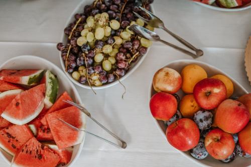 three bowls of fruit on a white table at Resort Fior di Sardegna in Posada