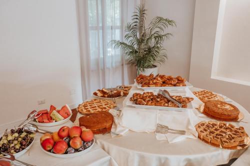 a table topped with lots of different types of food at Resort Fior di Sardegna in Posada