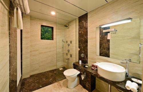 a bathroom with a sink and a toilet at Lords Inn Porbandar in Porbandar