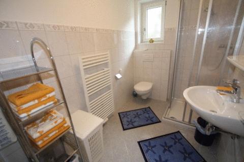 a white bathroom with a sink and a toilet at Appartements Markus in Ried im Zillertal