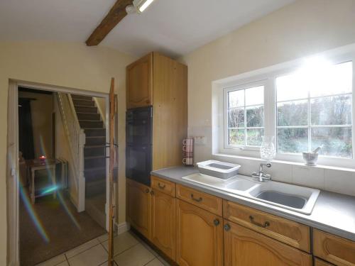 eine Küche mit einem Waschbecken und einem Fenster in der Unterkunft The Retreat in Whitchurch