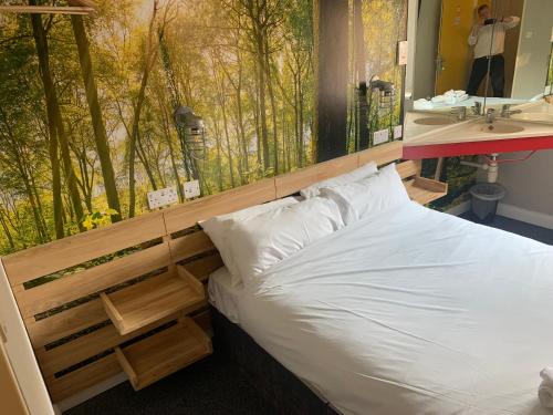 a bedroom with a bed and a bathroom with a sink at Metro Inns Newcastle in Newcastle upon Tyne
