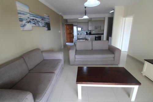 a living room with two couches and a coffee table at Saints View Resort Unit 3 in Uvongo Beach