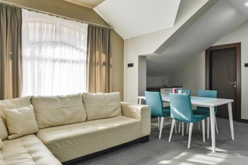 a living room with a couch and a table at Garni Hotel Aline in Šabac