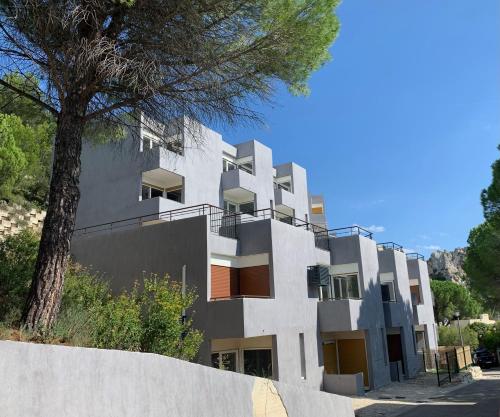 a white building with a tree in front of it at "Lou Mes" Baux-de-Provence Terrasse in Les Baux-de-Provence