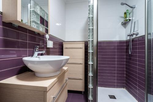 a bathroom with a sink and a shower with purple tiles at Apartamento Levante en Chinchilla con vistas in Chinchilla de Monte Aragón