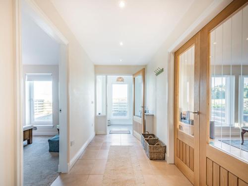 a hallway of a home with a door and windows at West Burnside Beach Cottage in Tayinloan