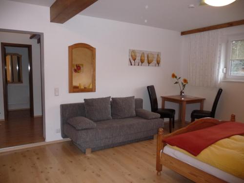 a living room with a couch and a bed at Familiengasthof St. Wolfgang in Spittal an der Drau